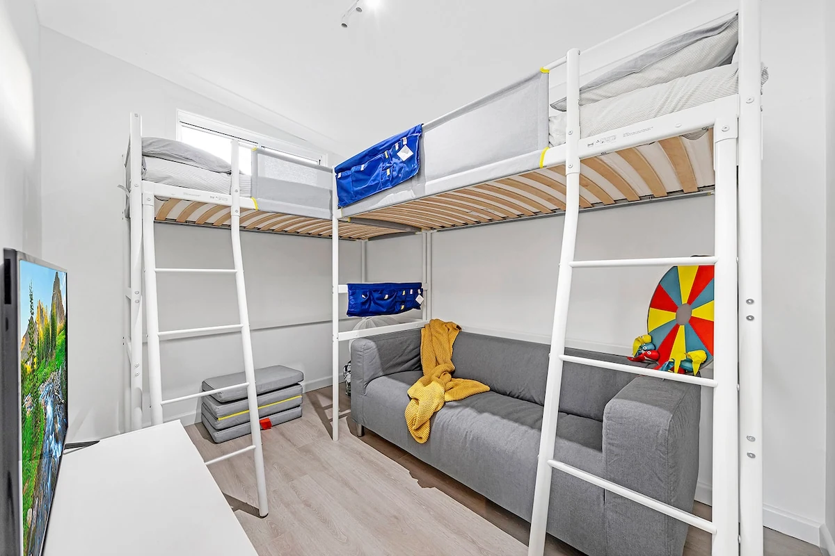 Second kids bunk room with TV, sofa and loft beds
