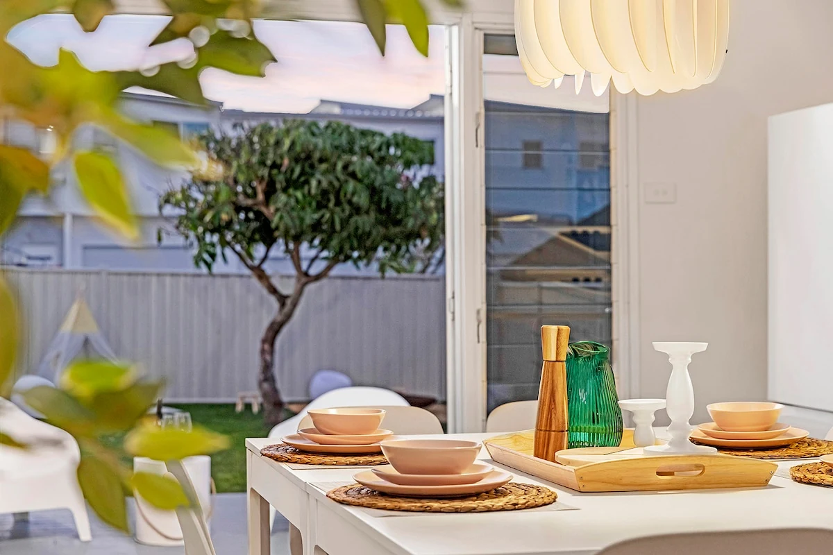 Styled dining table overlooking the backyard at Kos Koliba